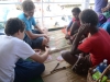 the Choate kids and their friends playing cards while they wait for the ship to depart